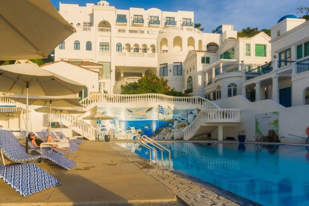 pool sorrounded with the white and blue theme hotel