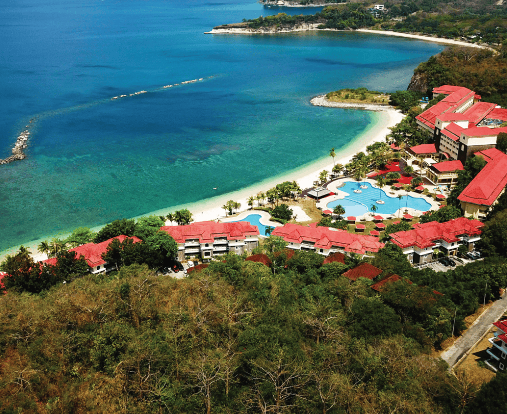 aerial view with the sea, trees and hotel view