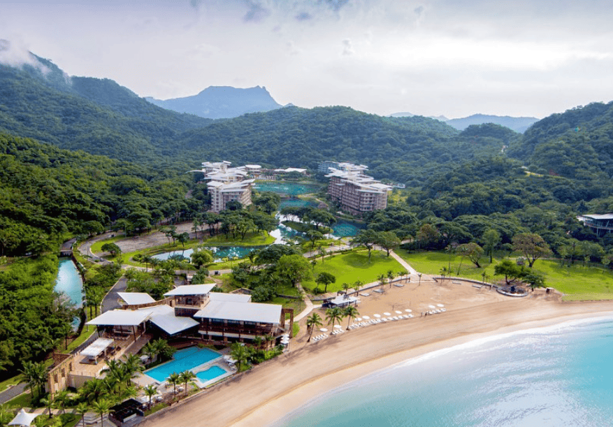 aerial view with sea trees, pool and hotel