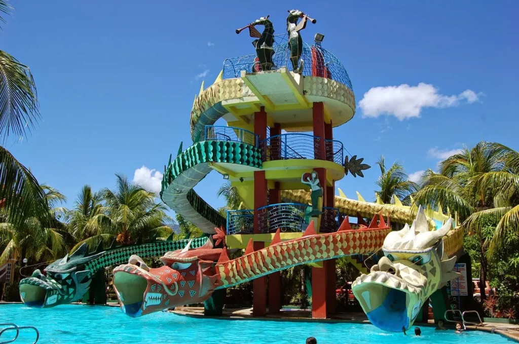 a pool and a slide in Covelandia du Labrador Beach Resort in pangasinan